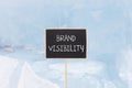 Brand visibility symbol. Concept words Brand visibility on beautiful yellow black blackboard. Beautiful blue ice background. Royalty Free Stock Photo