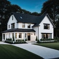 A brand white contemporary farmhouse with a dark shingled roof and black windows