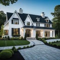 A brand white contemporary farmhouse with a dark shingled roof and black windows is seen in OAK on