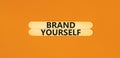 Brand yourself symbol. Concept words Brand yourself on beautiful wooden stick. Beautiful orange table orange background. Business Royalty Free Stock Photo