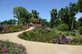 People walking through flowerbed of Marienberg Mountain park in