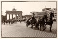 Brandenburg Gate, Berlin,with coachman on horse-drawn carriage, nostalgic retro style postcard in sepia tone