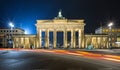 Brandenburger Tor in Berlin, by night with red traffic lights Royalty Free Stock Photo
