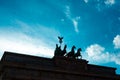Brandenburger Tor Brandenburg Gate, in shadow on blue sky with clouds, famous landmark in Berlin, Germany