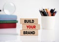 Branding or brand building in business and marketing. The message build your brand on wooden blocks Royalty Free Stock Photo