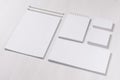 Branding business mock up of white blank stationery set on light soft white wooden background, inclined.