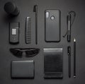 Black stylish male accessories kit on dark background. Top view