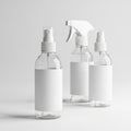 Three Clear Plastic Spray Bottles with Blank Labels on White Background Royalty Free Stock Photo
