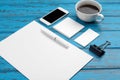 Branding stationery mockup on blue desk. Top view of paper, business card, pad, pens and coffee. Royalty Free Stock Photo