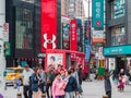 Brandname shops at Ximending Youth Shopping District, The `Harajuku` of Taipei with a group of tourist in foreground.