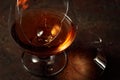 The drop of brandy falls into a broken glass Royalty Free Stock Photo