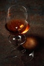 The drop of brandy falls into a broken glass Royalty Free Stock Photo