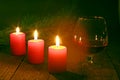 Brandy glass and candles on black background Royalty Free Stock Photo