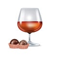 Brandy glass and chocolate candy Royalty Free Stock Photo