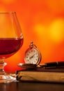 Brandy glass, diary and pocket watch Royalty Free Stock Photo