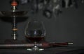 A brandy glass on a gray background, hookah tube Royalty Free Stock Photo
