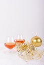 Brandy glasses with golden candle and decoration