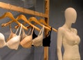 Bras on hangers and mannequin for fitting