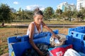 Brasilia, D.F., Brazil- June 11, 2019: A poor lady digging through the Trash in an affluent neighborhood to try and earn some mone