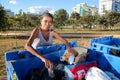 Brasilia, D.F., Brazil- June 11, 2019: A poor lady digging through the Trash in an affluent neighborhood to try and earn some mone