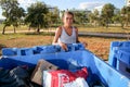 Brasilia, D.F., Brazil- June 11, 2019: A poor lady digging through the Trash in an affluent neighborhood to try and earn some mone