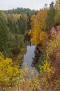 Brasla river running through red sandstone rocks grown by green and yellow forest in autumn. Royalty Free Stock Photo