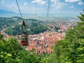 Brasov/Roamania - 06.28.2020: Cable car going to Mount Tampa summit with the city of Brasov in the background