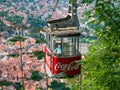 Brasov/Roamania - 06.28.2020: Man wearing a face mask in a cable car. Cable car with the city of Brasov in the background