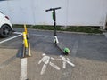 Brasov, Romania - April 8th 2022, Lime scooter parked in middle of pedestrian walk way.