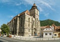 People walking George Baritiu street watching famous Black Church in the center of Brasov, Romania