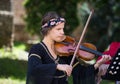 Brasov Romania-June 14 2018 : Beautiful girl violinist playing national Romanian music on the background of Brasov Royalty Free Stock Photo