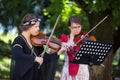 Brasov Romania-June 14 2018 : Beautiful girl violinist playing national Romanian music on the background of Brasov