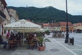 Terraces with tourists and residents in the Council Square of Brasov.