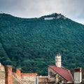 Brasov written with big letters on Mount Tampa. Brasov sign with old roofs and chimneys in the Royalty Free Stock Photo