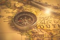 Brass antique compass on a old world map. Exploration concept background photo Royalty Free Stock Photo
