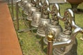 Brass bell hanging by a long line , metallic bells hanging in a row outside in thai temple Royalty Free Stock Photo