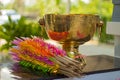 Brass bowl and bamboo wrapped in colored paper.