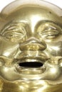 Brass Buddha face with laughing expression