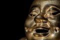 Brass buddha. Happy laughing monk face in close-up Royalty Free Stock Photo