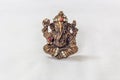 Brass carved lord ganesha idol in metallic colour with artificial stone carvings in a white backdrop Royalty Free Stock Photo