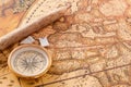 Brass compass and a wooden pencil for notes lie on an old vintage map