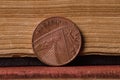 Brass copper coin against old book