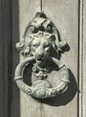 Brass door knocker on old door with lion& x27;s head Royalty Free Stock Photo