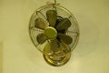 Brass fan on white wall