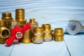 Brass fittings and wrench on blue boards close up. Plumbing repair idea Royalty Free Stock Photo