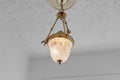 Brass Gold Vintage Historic Chandlier with Glass Pendant and Decorative Ceiling Medallion and Textured Ceiling
