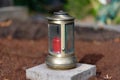 brass grave light with red grave candle Royalty Free Stock Photo