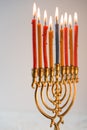 Brass hanukiya with lighted candles side view Royalty Free Stock Photo