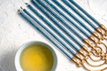 Brass Hanukiya Menorah with blue candles and butter in a bowl diagonal Royalty Free Stock Photo