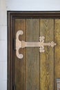 Brass hinge ornament on brown wooden door